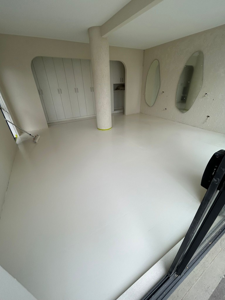 White epoxy-coated floor in residential basement room