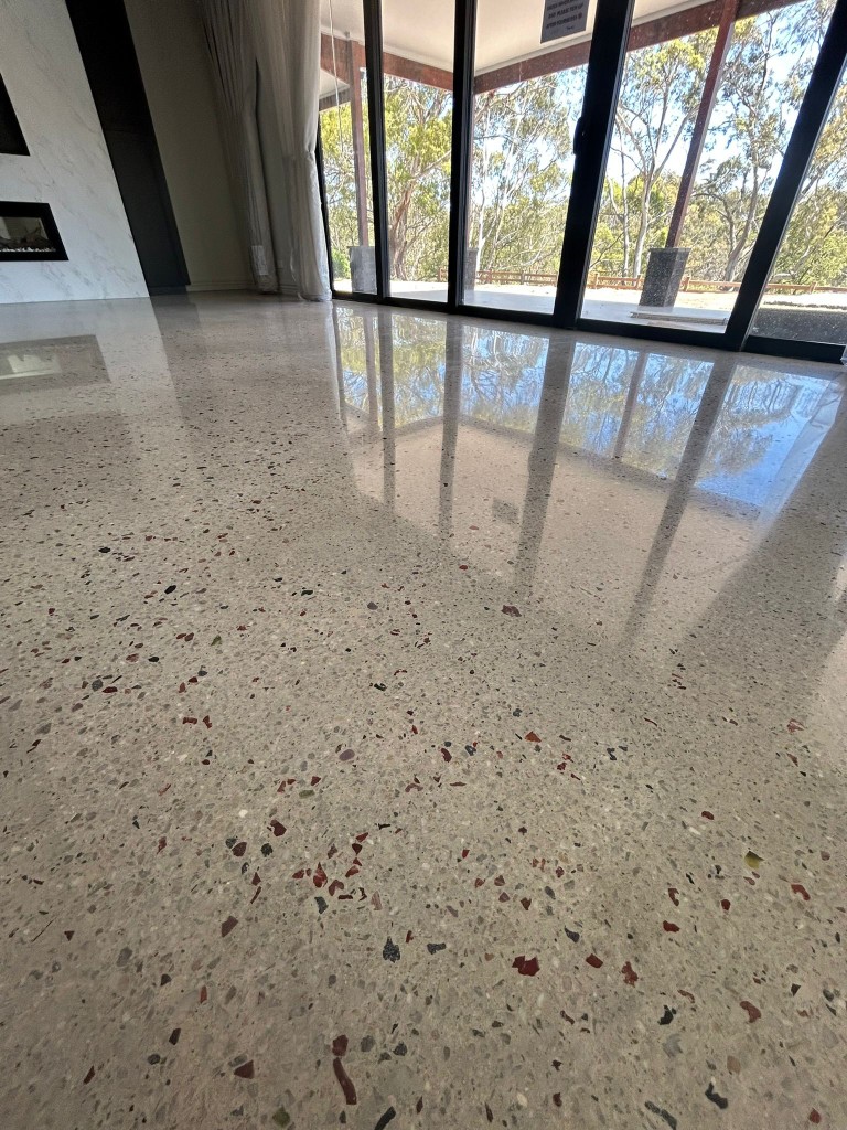 Mirror-polished terrazzo with marble fireplace by Claraseal Melbourne