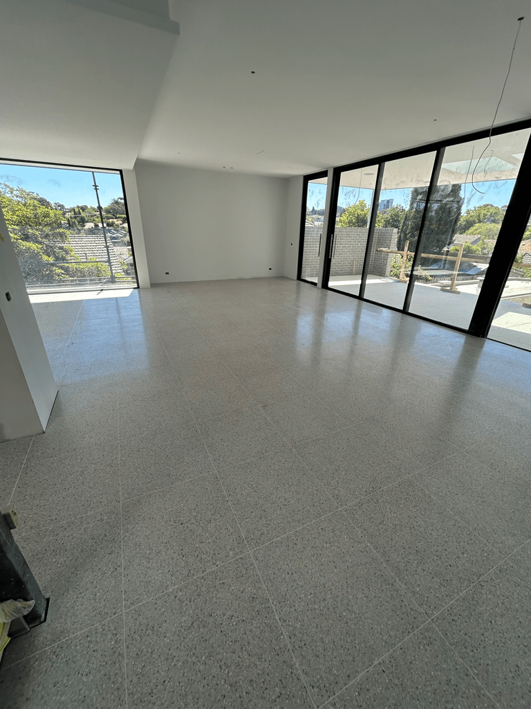 Freshly polished terrazzo floor in modern Melbourne new build with floor-to-ceiling windows and city-fringe views